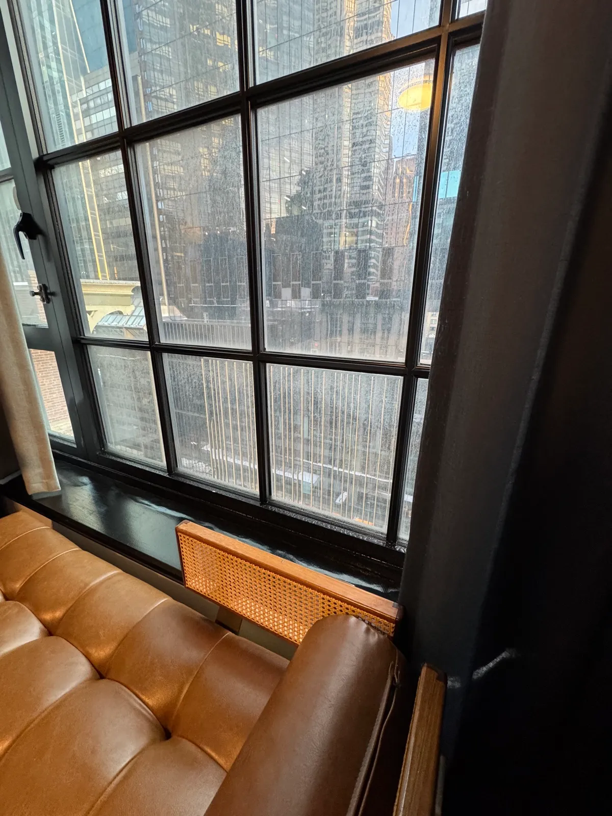 Snow-covered cityscape seen through a hotel window